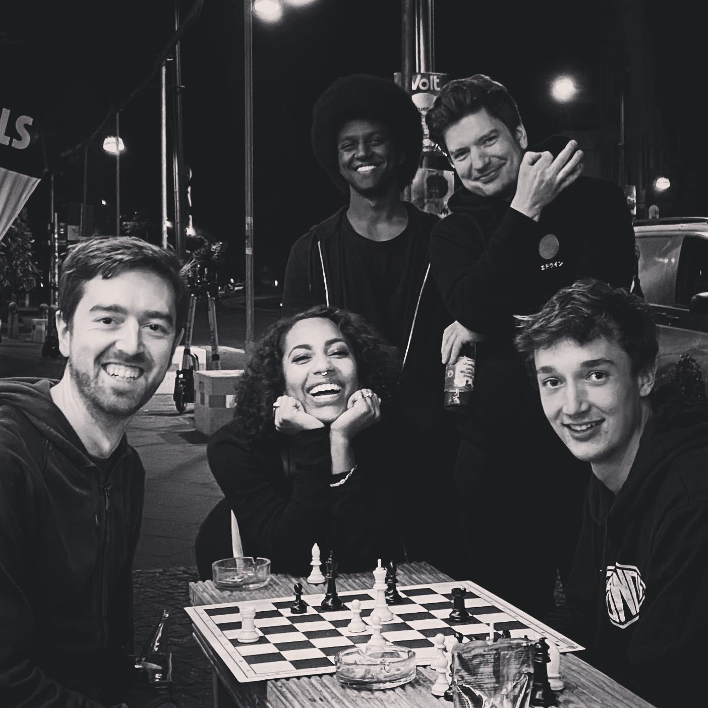 A group of chess players posing for a photo all smiling
