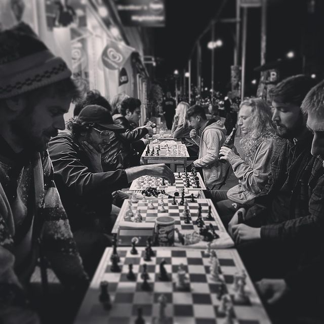 A picture of people playing chess outside